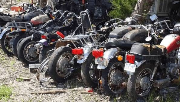 Row of old two-wheelers and motorcycles waiting to be scrapped